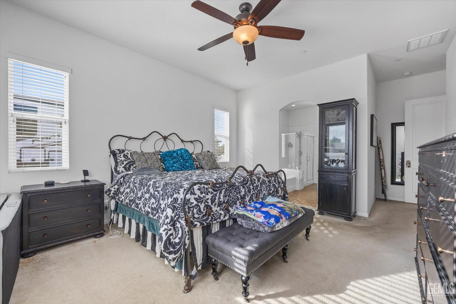 Undisclosed Address Bakersfield, CA 93314 - Photo 29 of 56 a bedroom with a bed and a chandelier