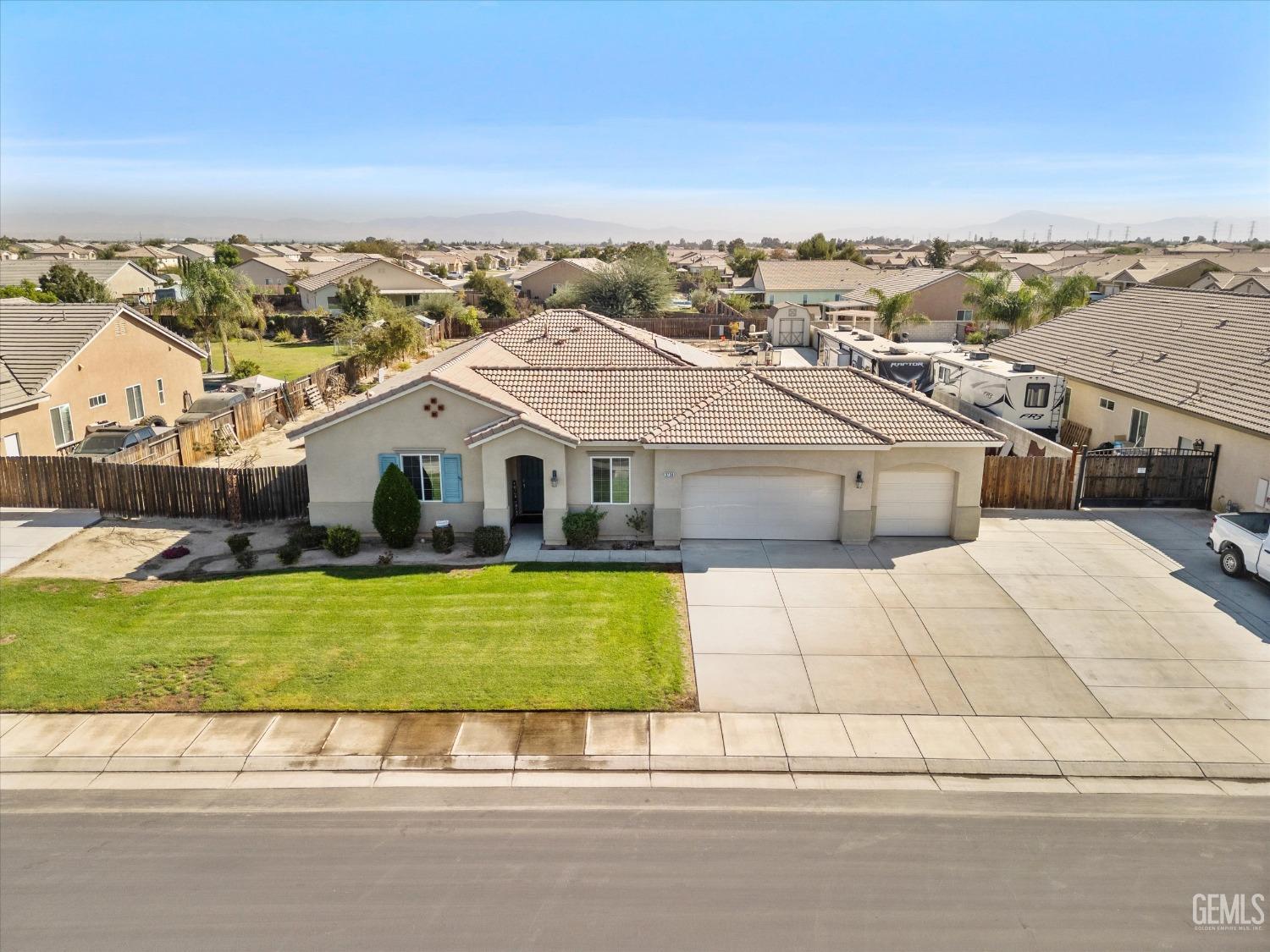 Undisclosed Address Bakersfield, CA 93314 - Photo 3 of 56 a aerial view of a house with a yard