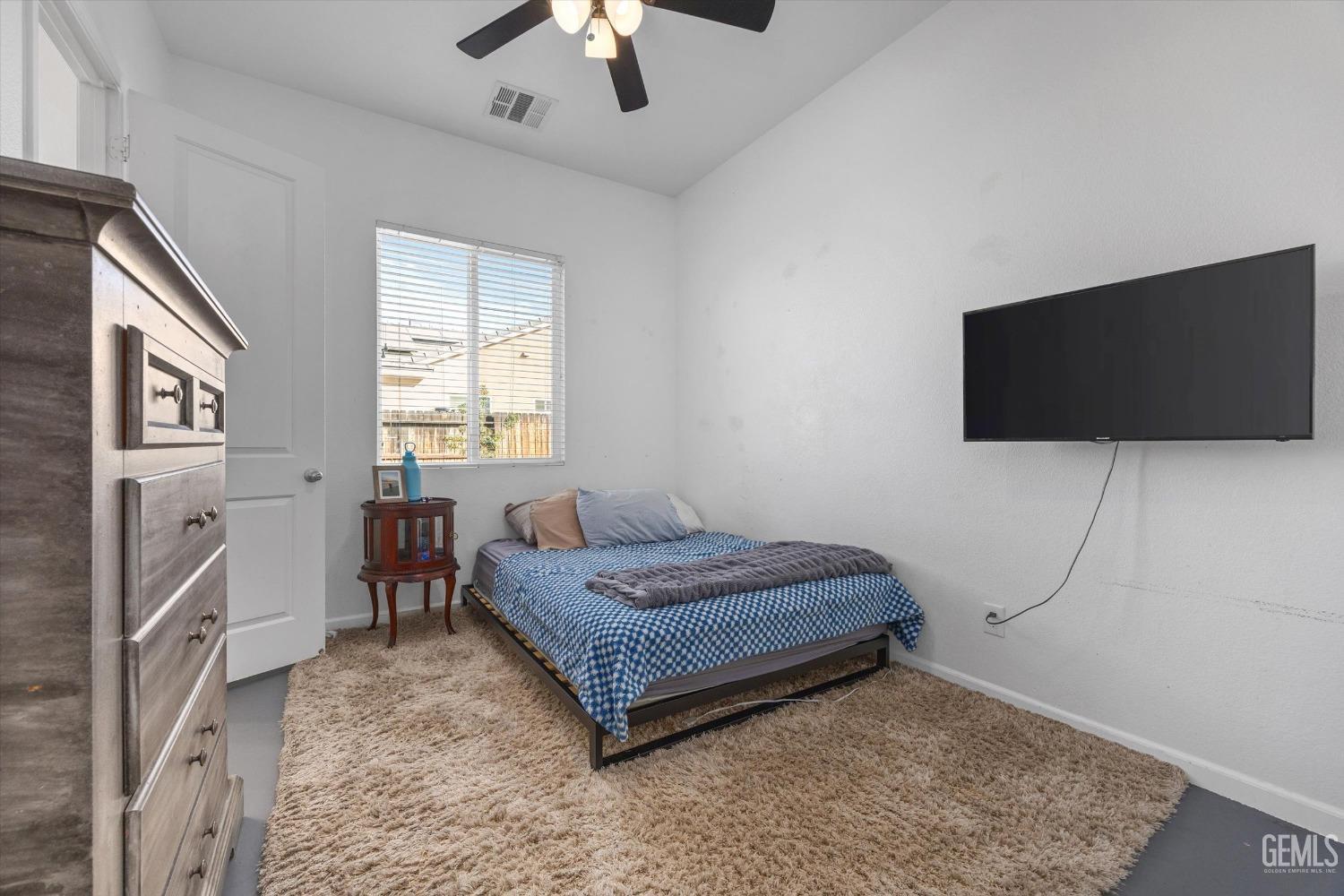 Undisclosed Address Bakersfield, CA 93314 - Photo 35 of 56 a bedroom with a bed and a flat screen tv