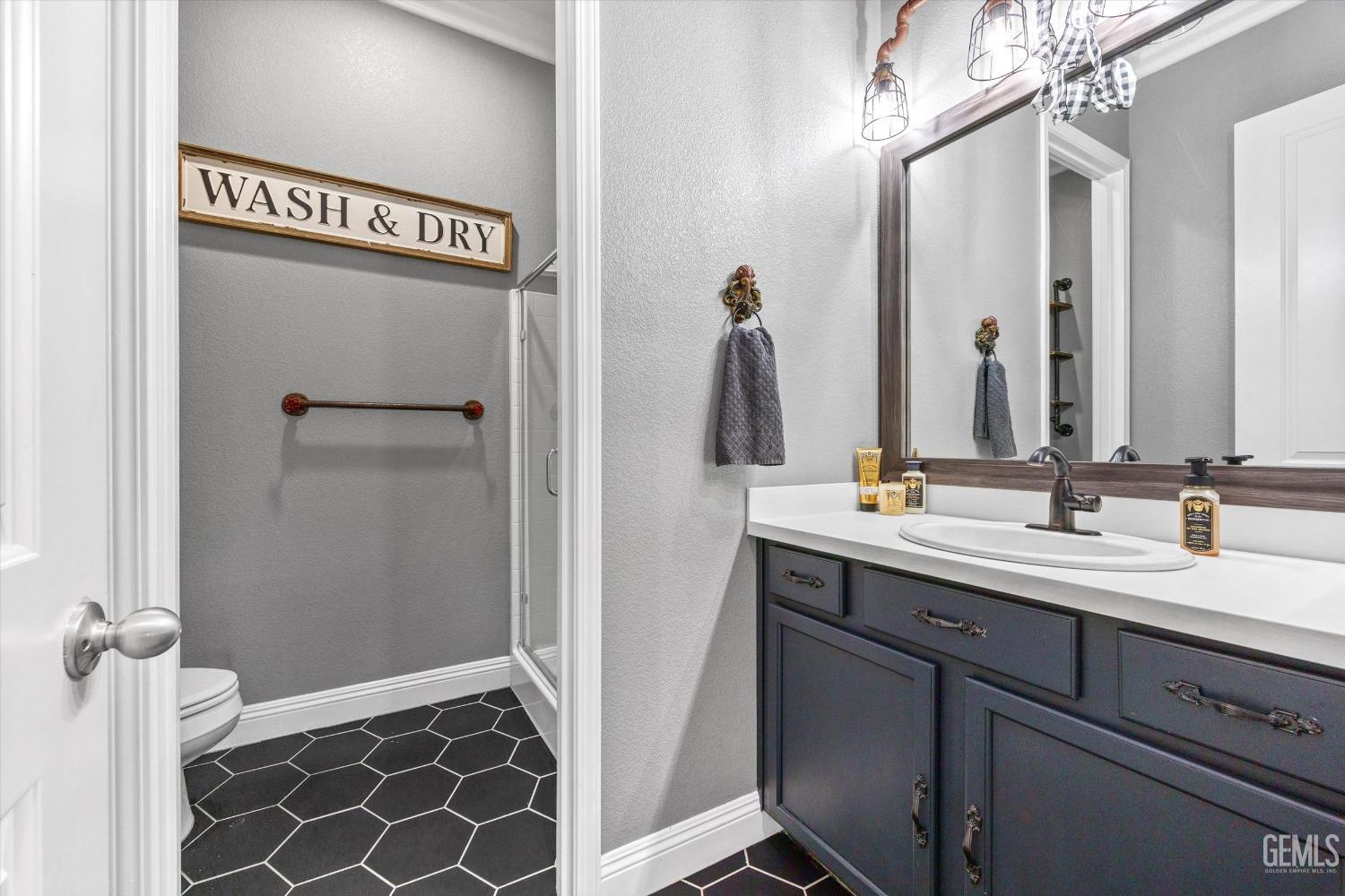 Undisclosed Address Bakersfield, CA 93314 - Photo 38 of 56 a bathroom with a double vanity sink and a mirror