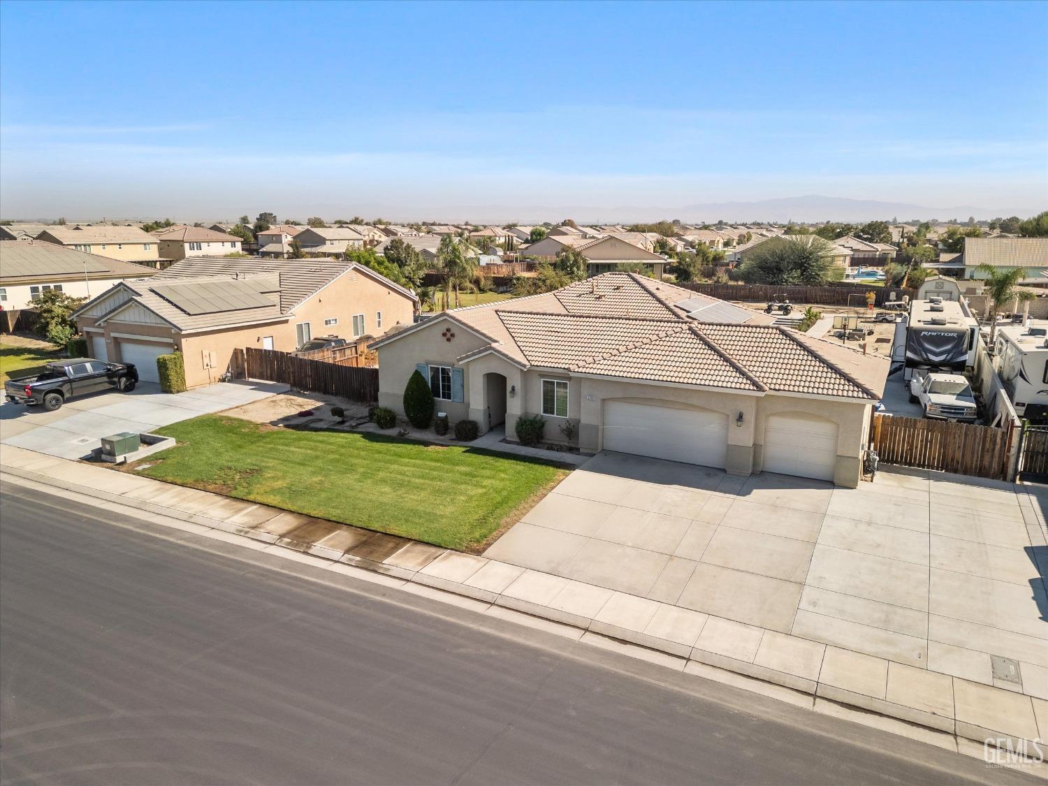 Undisclosed Address Bakersfield, CA 93314 - Photo 4 of 56 an aerial view of a house with a garden