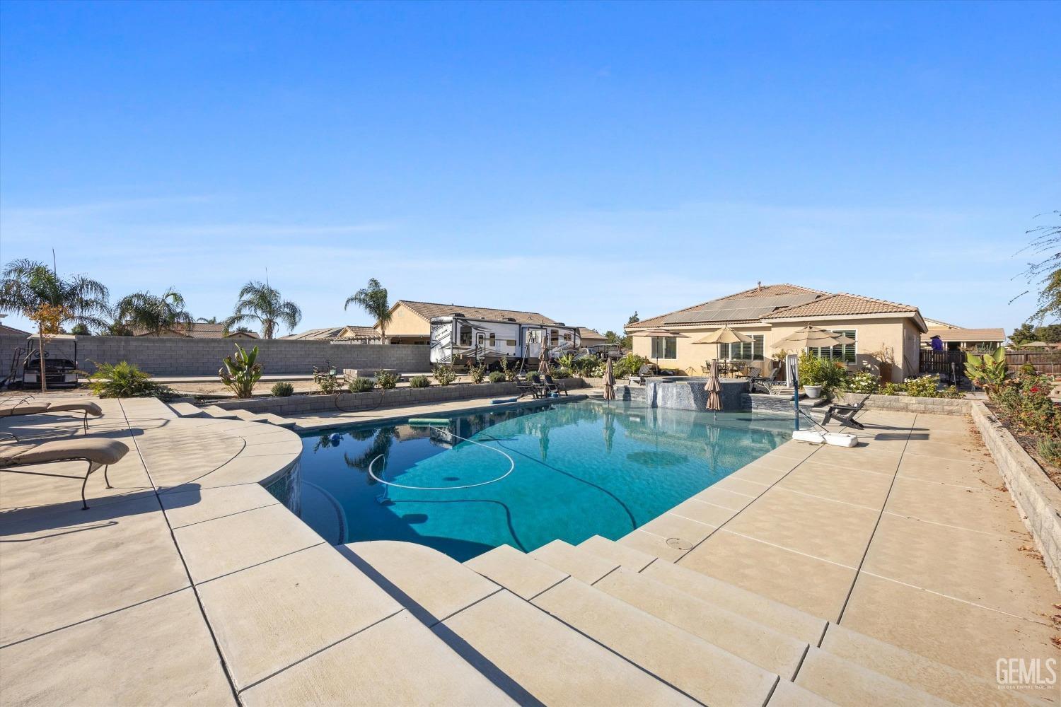 Undisclosed Address Bakersfield, CA 93314 - Photo 46 of 56 a view of a swimming pool with lounge chairs