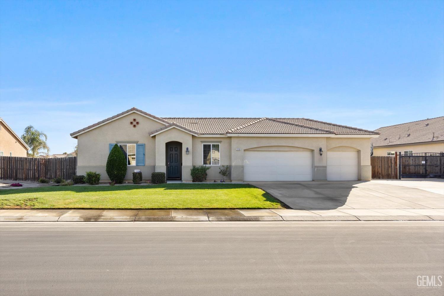 Undisclosed Address Bakersfield, CA 93314 - Photo 9 of 56 a view of a white house with a yard and plants