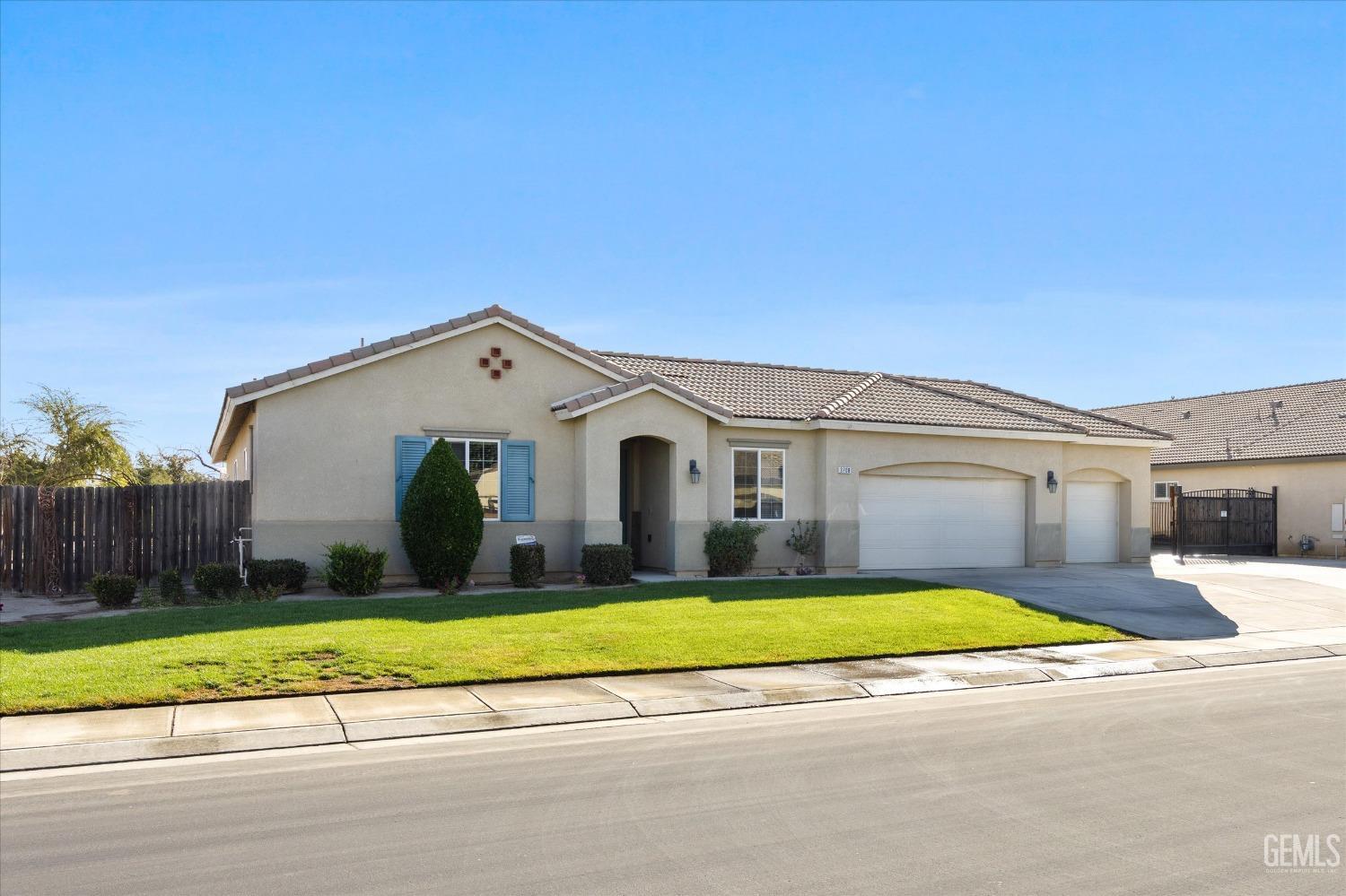 Undisclosed Address Bakersfield, CA 93314 - Photo 10 of 56 a view of a house with a big yard and large trees