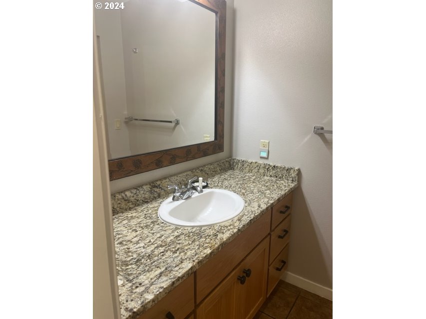 18575 Southwest Century Drive, Unit 1721&22 Bend, OR 97702 - Photo 11 of 40 a bathroom with a granite countertop sink and a mirror