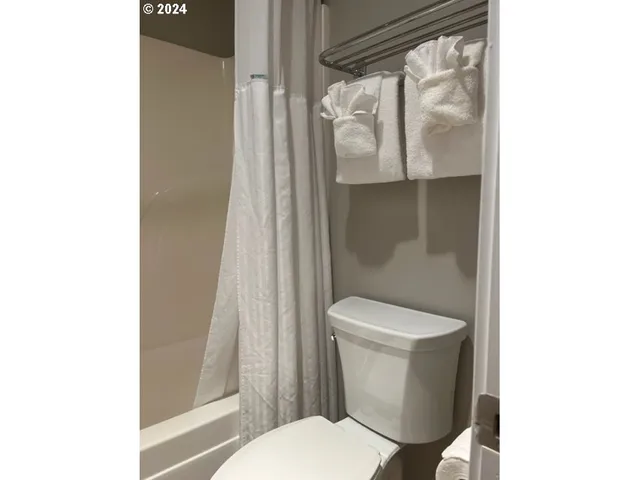 a white toilet sitting next to a bathroom sink