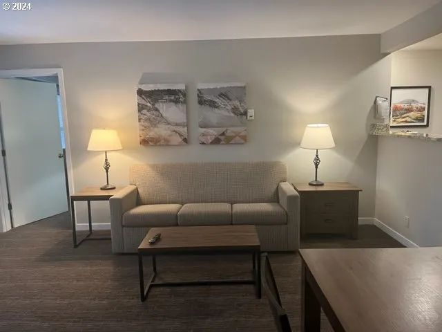 a living room with furniture and a lamp