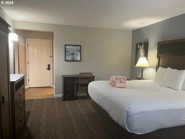 a bedroom with a bed and a flat screen tv