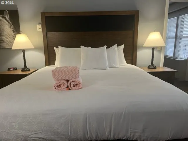 a bedroom with a bed and a lamp