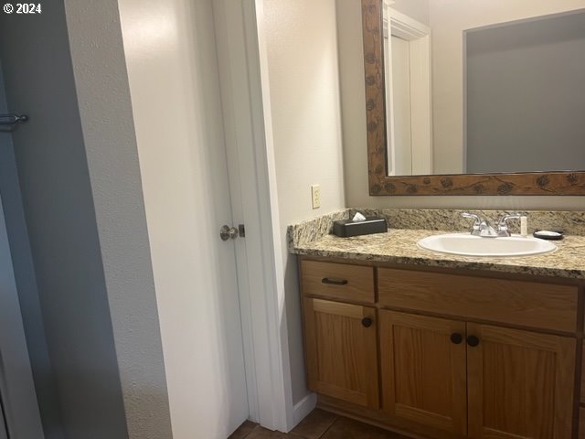 18575 Southwest Century Drive, Unit 1721&22 Bend, OR 97702 - Photo 36 of 40 a bathroom with a sink and a mirror