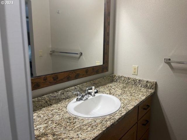 18575 Southwest Century Drive, Unit 1721&22 Bend, OR 97702 - Photo 37 of 40 a bathroom with a granite countertop sink and a mirror