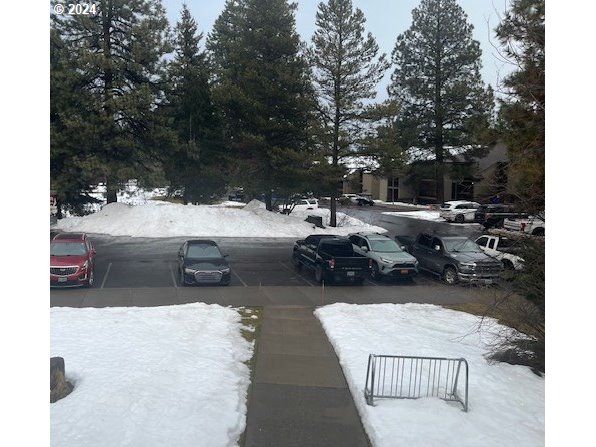 18575 Southwest Century Drive, Unit 1721&22 Bend, OR 97702 - Photo 39 of 40 a view of a patio with dining table and chairs with wooden fence