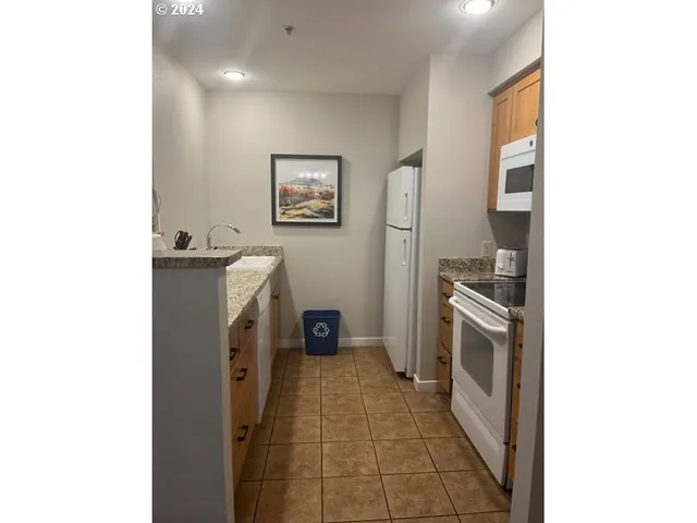 a kitchen with a refrigerator and a stove