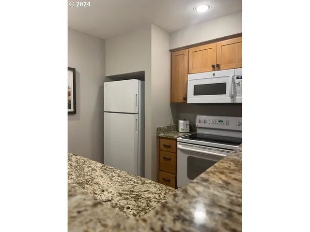 a kitchen with a refrigerator and a microwave