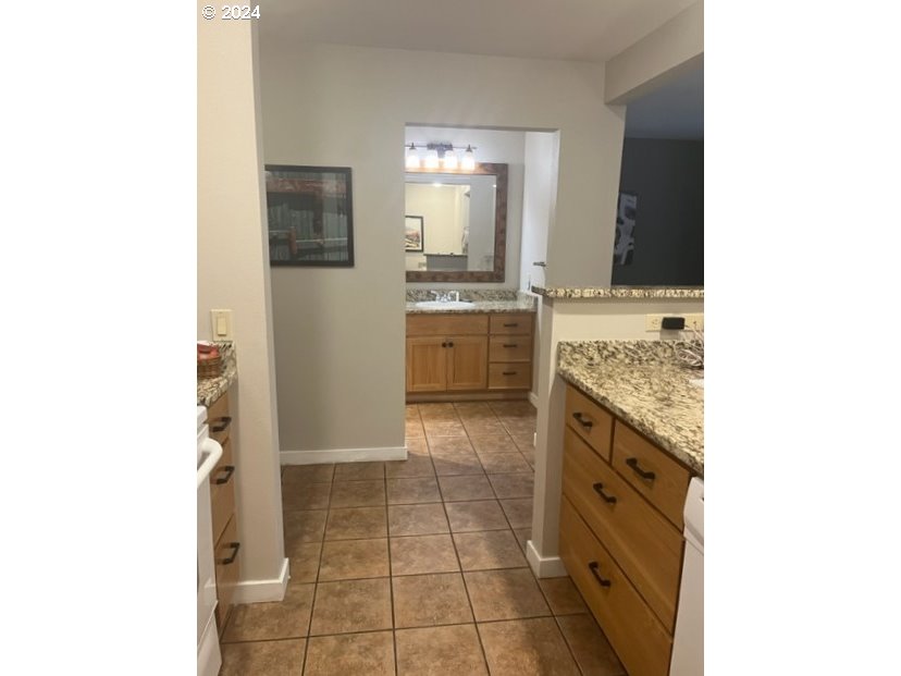 18575 Southwest Century Drive, Unit 1721&22 Bend, OR 97702 - Photo 10 of 40 a bathroom with a granite countertop sink and mirror
