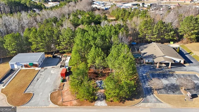 an aerial view of a house with a yard basket ball court and outdoor seating