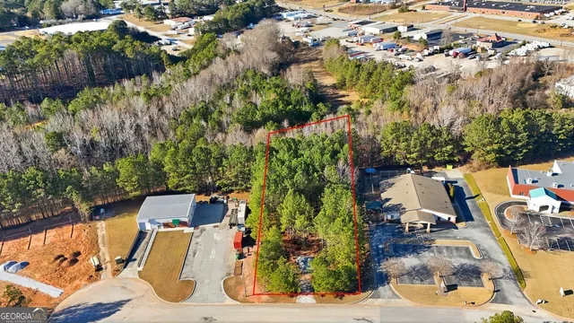an aerial view of residential houses with yard