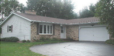 11873 Tresemer Road Roscoe, IL 61073 - Photo 1 of 6 a view of a house with a yard and garage