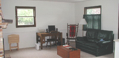 11873 Tresemer Road Roscoe, IL 61073 - Photo 5 of 6 a living room with furniture a window and a flat screen tv