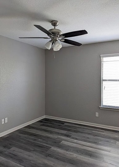 7703 Redstone Manor Converse, TX 78109 - Photo 16 of 28 Unfurnished room with a textured ceiling, ceiling fan, and dark wood finished floors