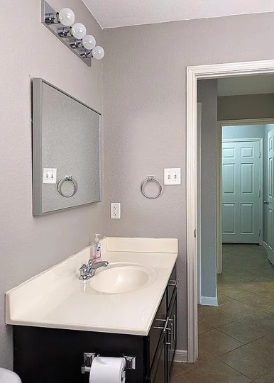 7703 Redstone Manor Converse, TX 78109 - Photo 22 of 28 Bathroom with vanity and dark tile patterned flooring