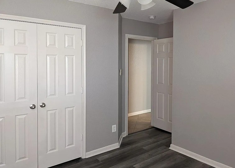 7703 Redstone Manor Converse, TX 78109 - Photo 23 of 28 Unfurnished bedroom featuring a ceiling fan, a closet, and dark wood finished floors