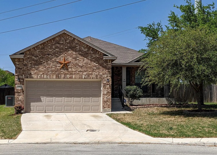 7703 Redstone Manor Converse, TX 78109 - Photo 28 of 28 View of front of house featuring concrete driveway, a garage, brick siding, and roof with shingles