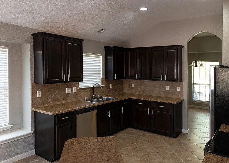 7703 Redstone Manor Converse, TX 78109 - Photo 5 of 28 Kitchen featuring stainless steel appliances, decorative backsplash, dark wood finish cabinets, arched walkways, and recessed lighting