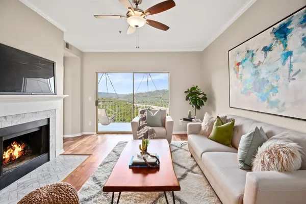a living room with furniture fireplace and window