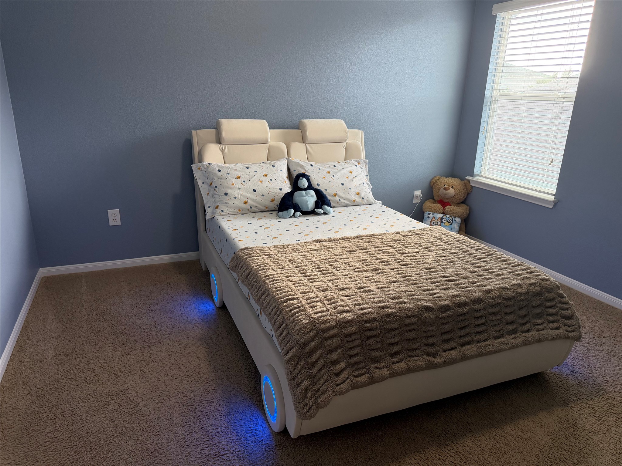 12111 Riprap Drive Manor, TX 78653 - Photo 10 of 14 a bed sitting in a bedroom next to a window