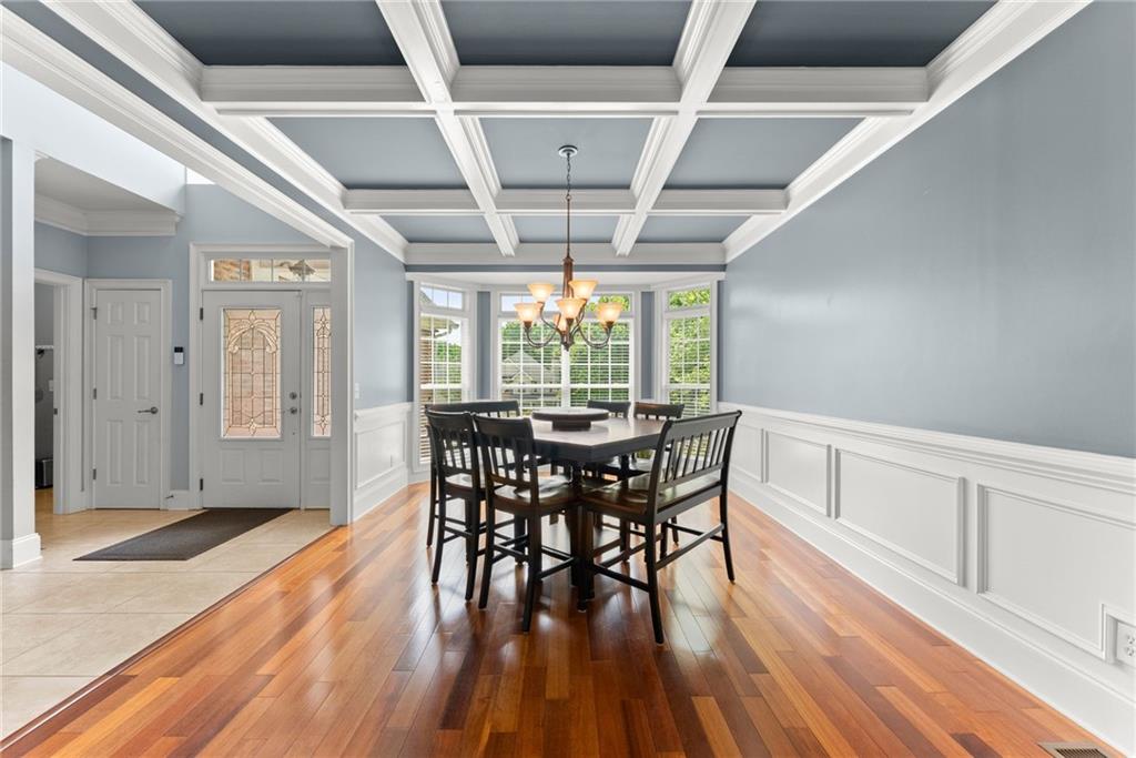 6643 Windvane Point Clermont, GA 30527 - Photo 11 of 88 a dining room with furniture window wooden floor