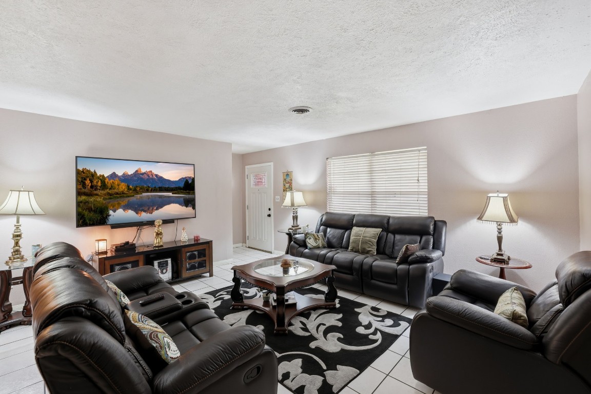 10922 Ivyridge Road Houston, TX 77043 - Photo 3 of 17 a living room with furniture a flat screen tv and a window
