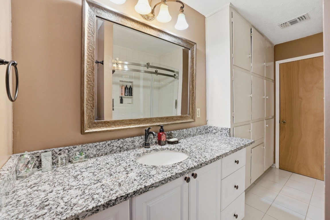 10922 Ivyridge Road Houston, TX 77043 - Photo 9 of 17 a bathroom with a granite countertop sink and a mirror