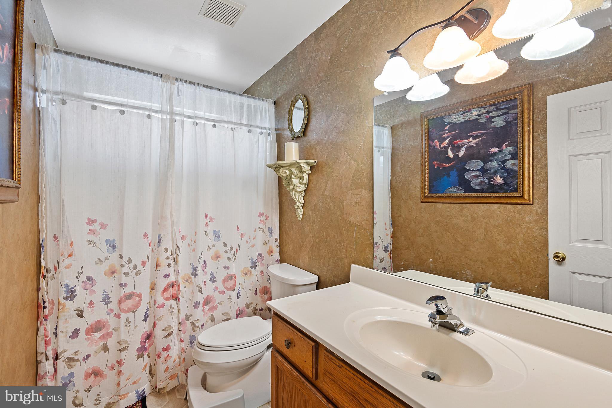 3 Kerrin Road Bear, DE 19701 - Photo 18 of 25 a bathroom with a sink a toilet and shower curtain