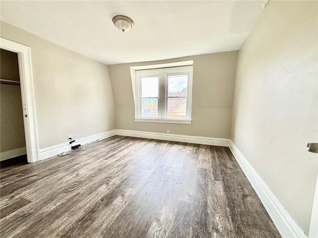 352 2nd Street, Unit 3 Pitcairn, PA 15140 - Photo 2 of 8 an empty room with wooden floor and windows