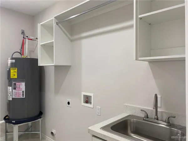 a room with a sink and cabinets