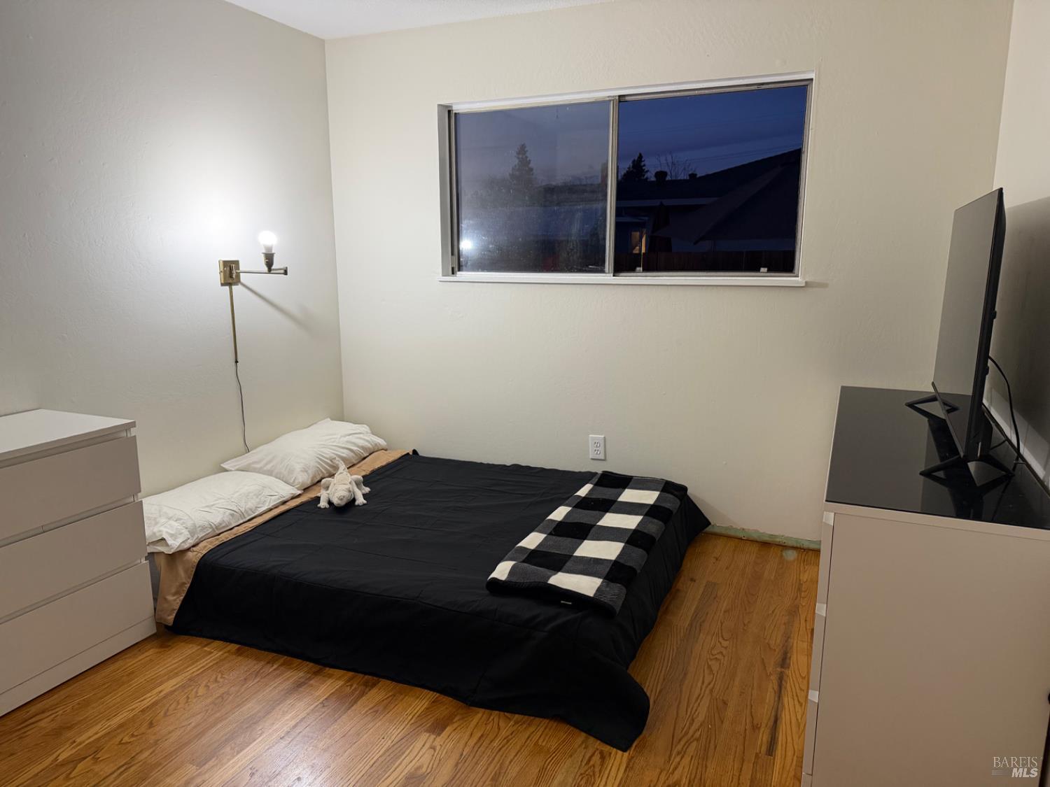 611 Willrush Street Santa Rosa, CA 95401 - Photo 17 of 19 a bedroom with a bed and a flat tv screen on the dresser