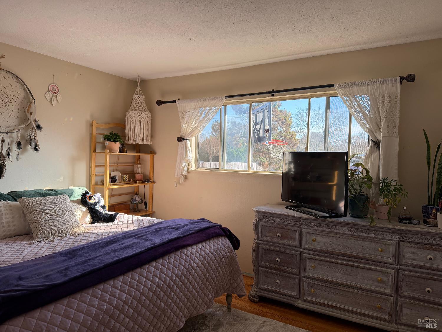 611 Willrush Street Santa Rosa, CA 95401 - Photo 10 of 19 a bedroom with a bed and a flat screen tv