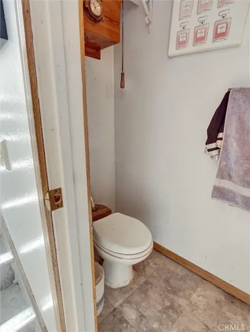 a white toilet sitting next to a shower