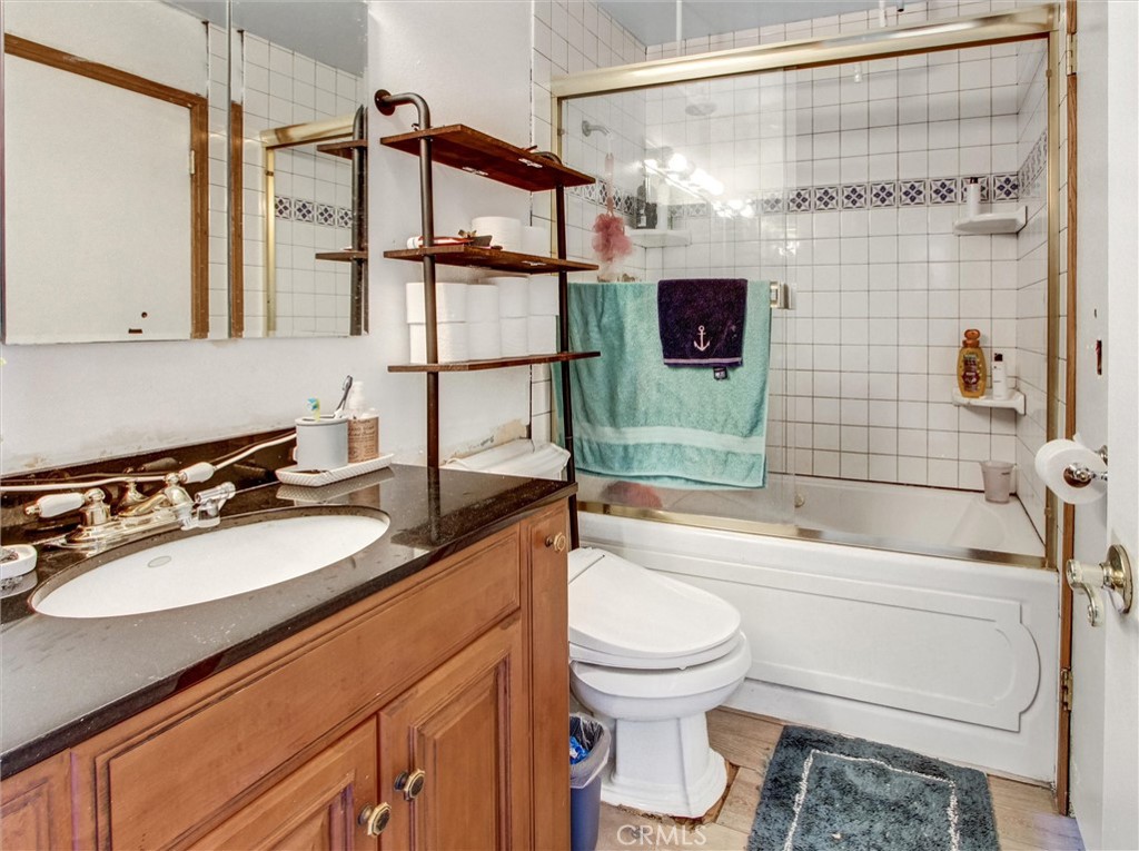10552 Royal Oak Way Stanton, CA 90680 - Photo 14 of 21 a bathroom with a sink a toilet and shower