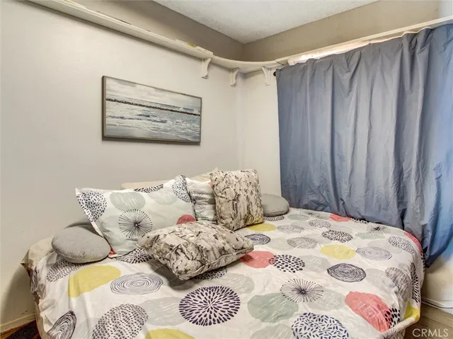a bedroom with a bed and a painting on the wall