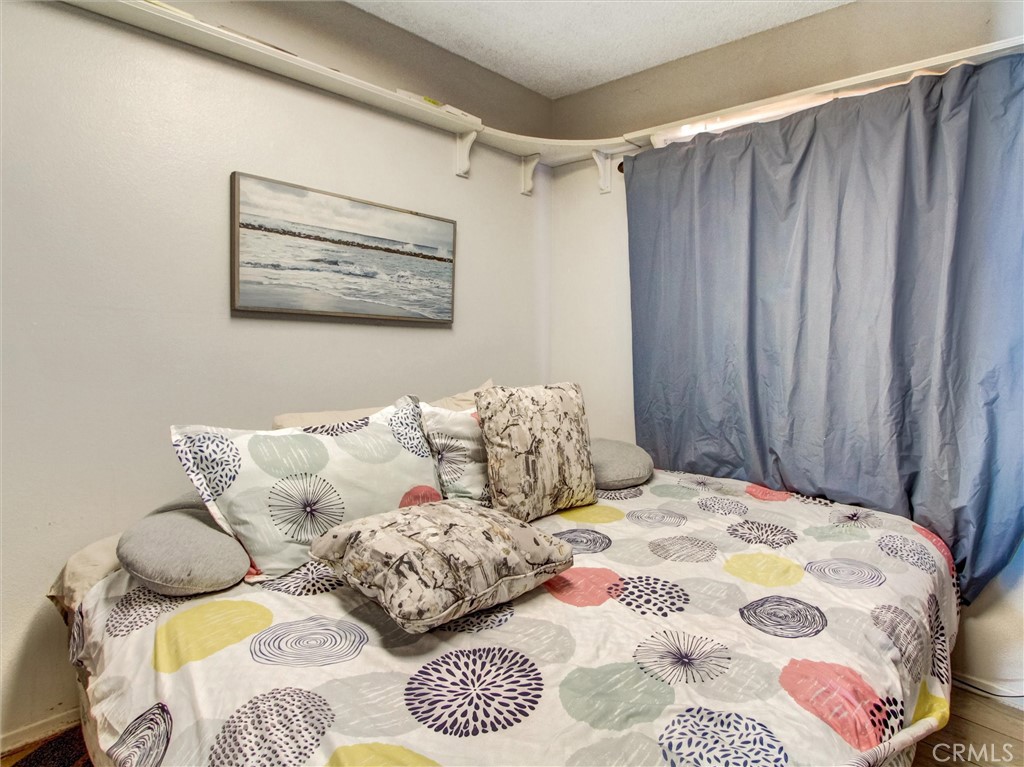 10552 Royal Oak Way Stanton, CA 90680 - Photo 15 of 21 a bedroom with a bed and a painting on the wall