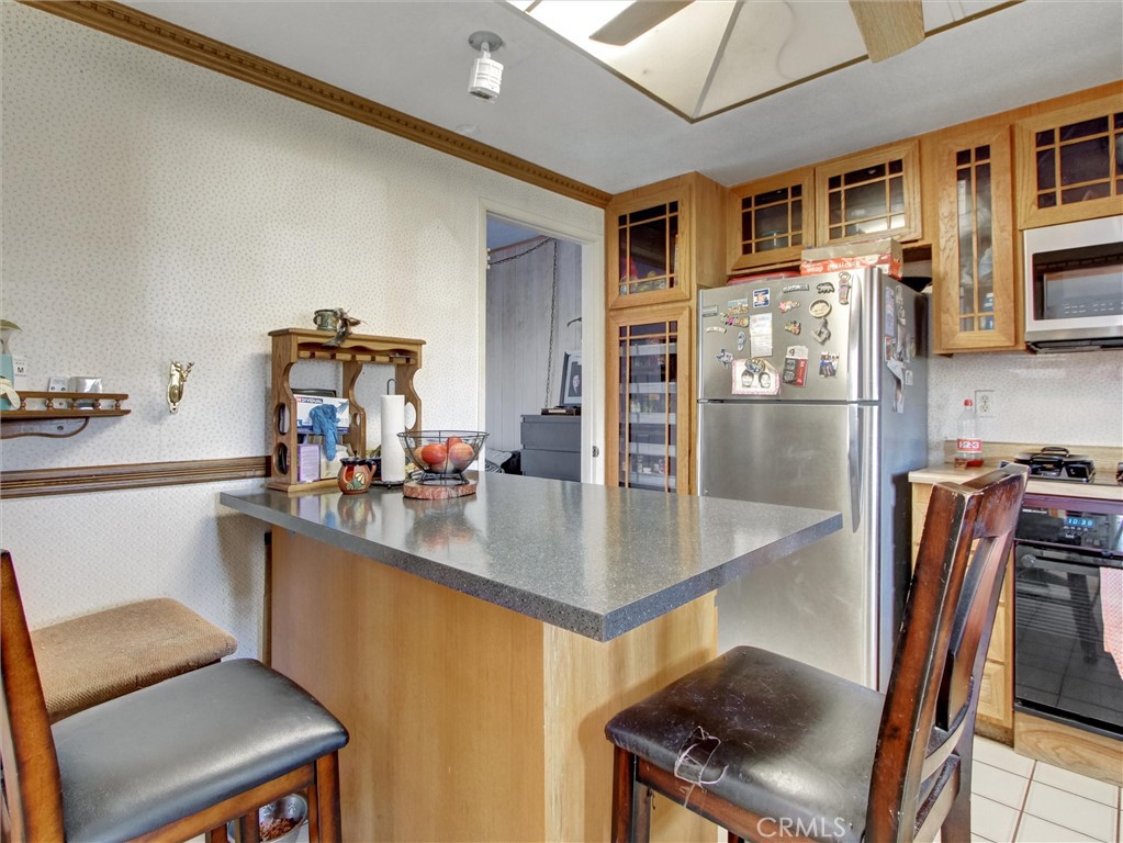 10552 Royal Oak Way Stanton, CA 90680 - Photo 6 of 21 a kitchen with stainless steel appliances granite countertop a sink refrigerator and cabinets