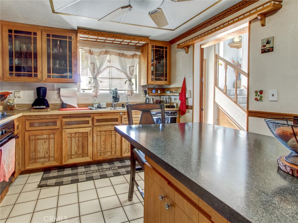 10552 Royal Oak Way Stanton, CA 90680 - Photo 7 of 21 a kitchen with a sink and wooden cabinets