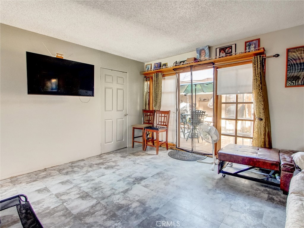 10552 Royal Oak Way Stanton, CA 90680 - Photo 8 of 21 a living room with furniture and a flat screen tv