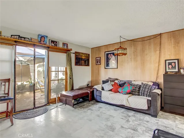 a living room with furniture and a floor to ceiling window