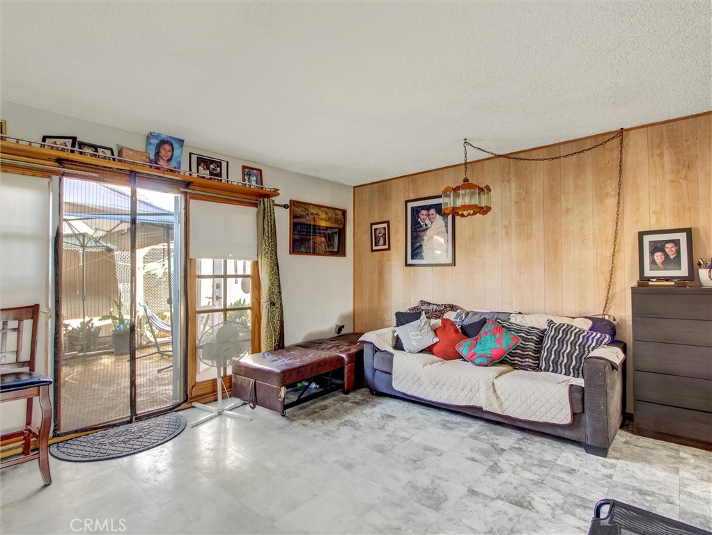 10552 Royal Oak Way Stanton, CA 90680 - Photo 9 of 21 a living room with furniture and a floor to ceiling window