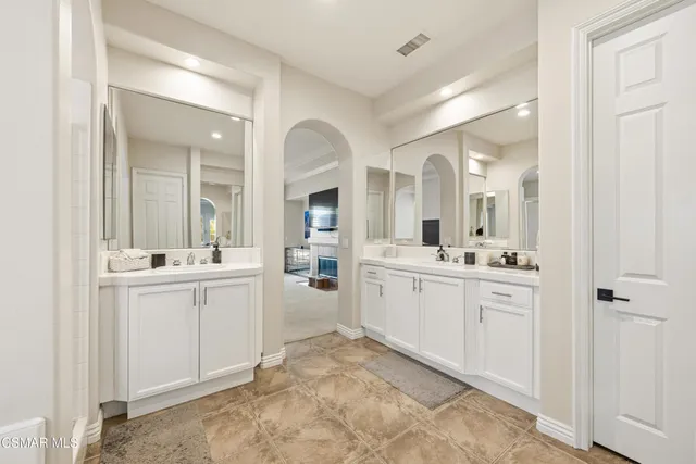 a spacious bathroom with a granite countertop sink and a mirror