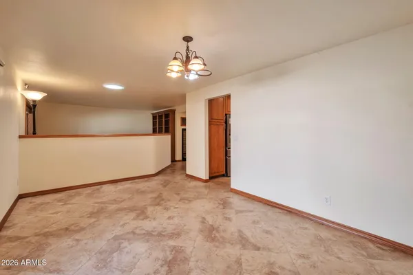 a view of a chair and tables in the balcony