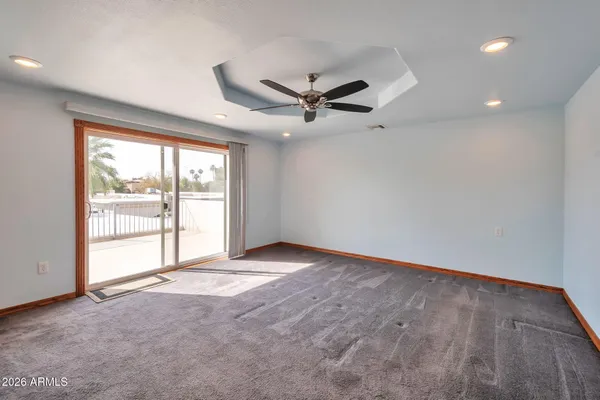 a view of a deck with a big yard potted plants and large tree